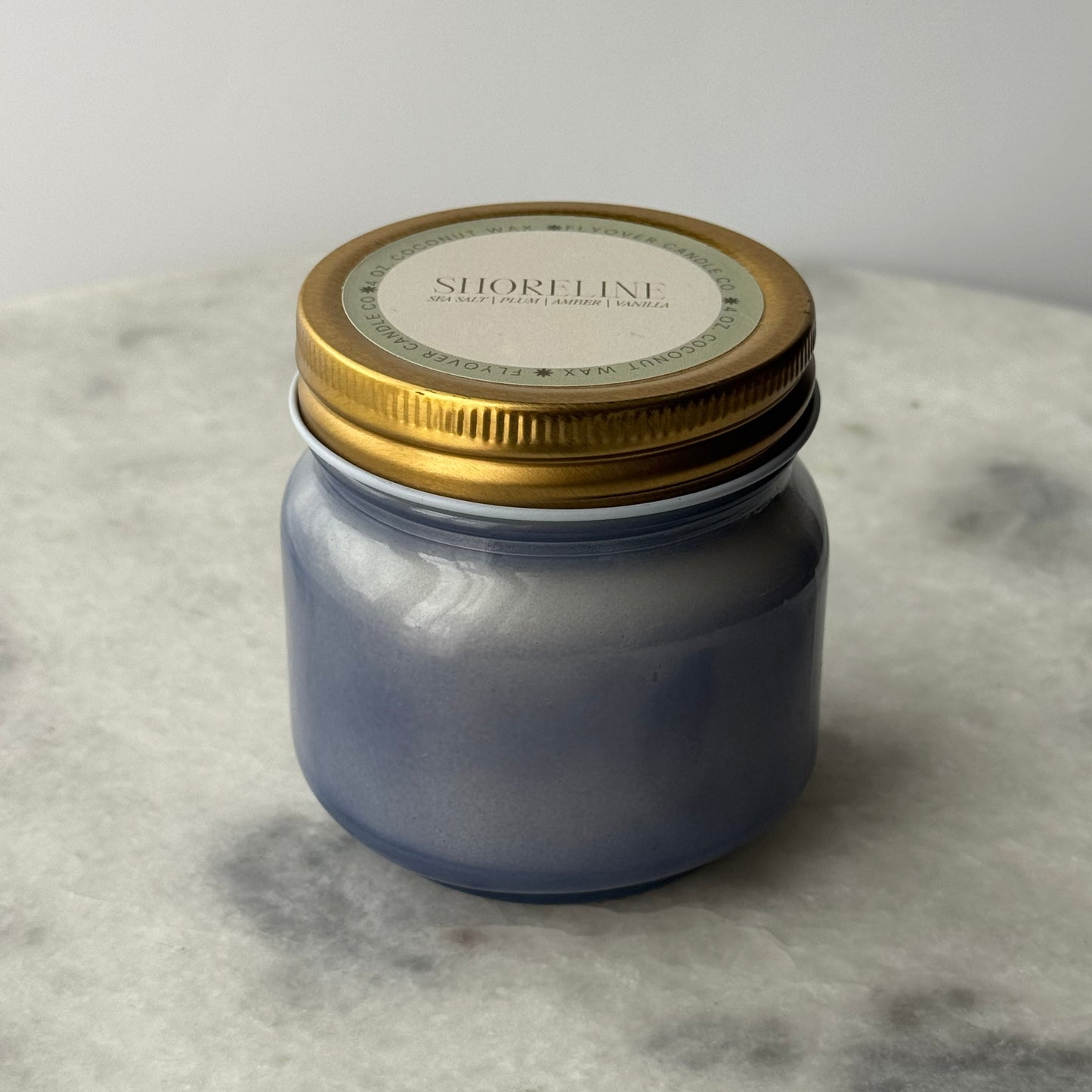 Jar with a gold lid on a marble surface
