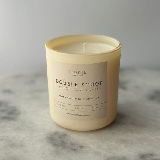 Candle with a label on a gray surface